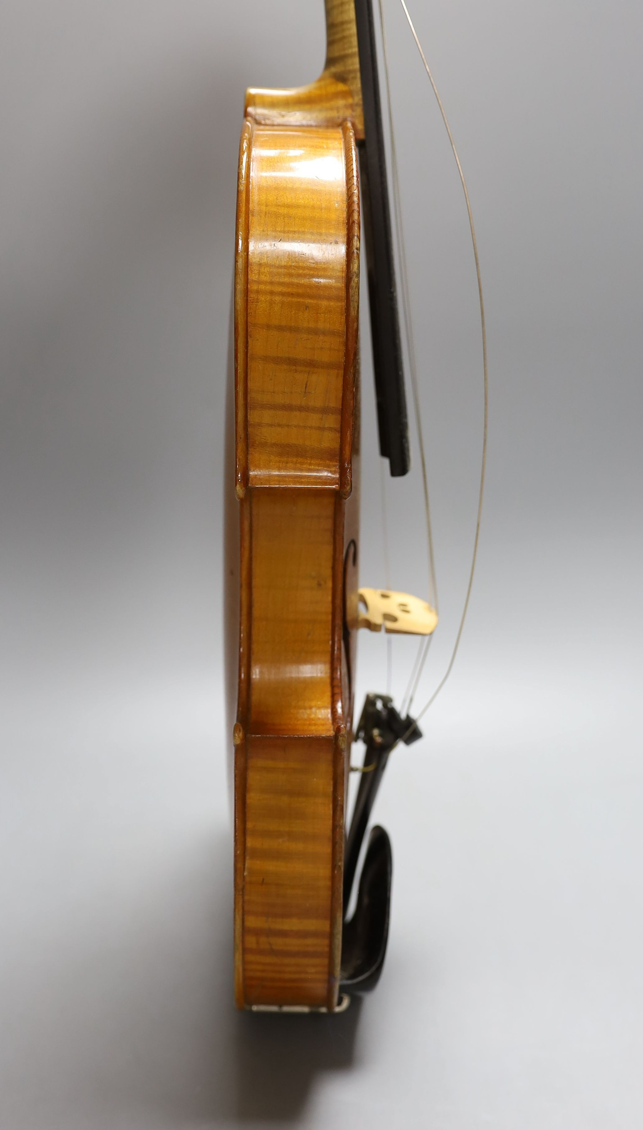 A 20th century violin in case with two bows, length of back 35.5cm